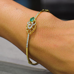 Floral pattern bracelet with green colored stone