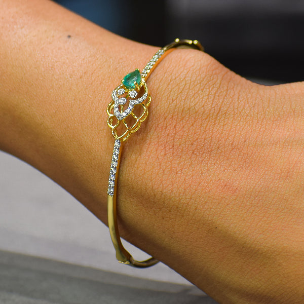 Floral pattern bracelet with green colored stone